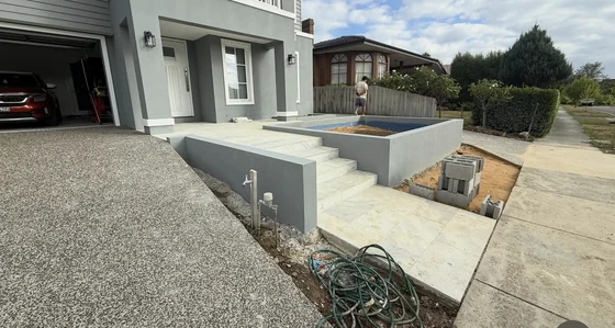 Rendered retaining walls framing entrance steps