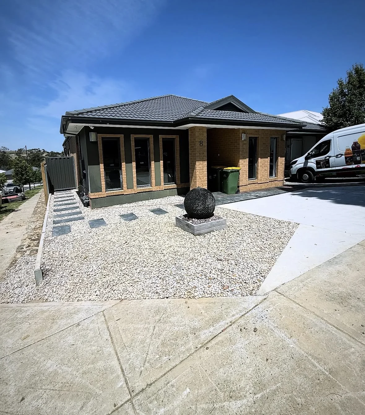 Contemporary home with stepping stones, gravel landscaping and a feature planter