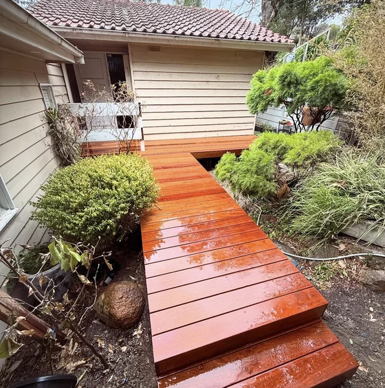Finished timber garden boardwalk connecting a home to its garden
